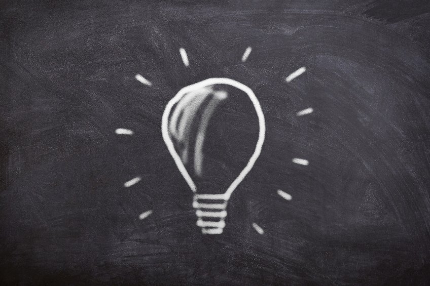 Electric bulb, written with white chalk on a black chalkboard with stripes around.
