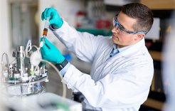 Bioprocess engineer Dr.-Ing. Sven Göbel during his research work in a laboratory at the Max Planck Institute in Magdeburg, takeing a sample from a bioreactor for analyzing the virus yield.